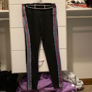 Black leggings with red, blue, and silver stripes down sides
